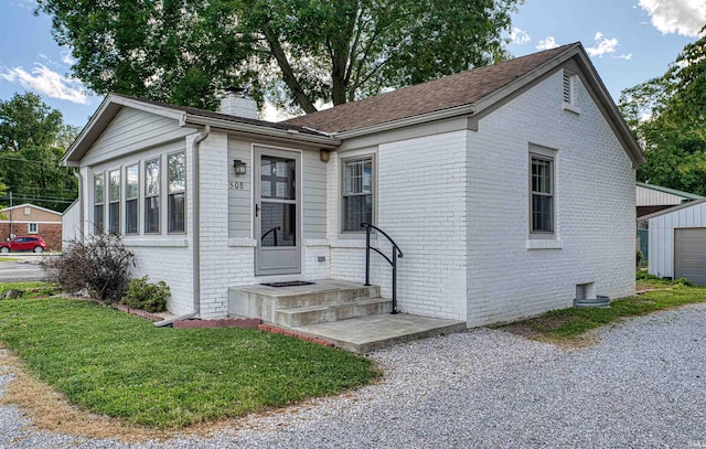 508 Polk St, Newburgh, IN 47630 - view of front of house featuring brick siding, a chimney, and an outdoor structure