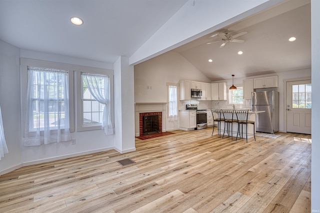 508 Polk St, Newburgh, IN 47630 - living room with a ceiling fan, recessed lighting, light wood-style flooring, high vaulted ceiling, and a brick fireplace