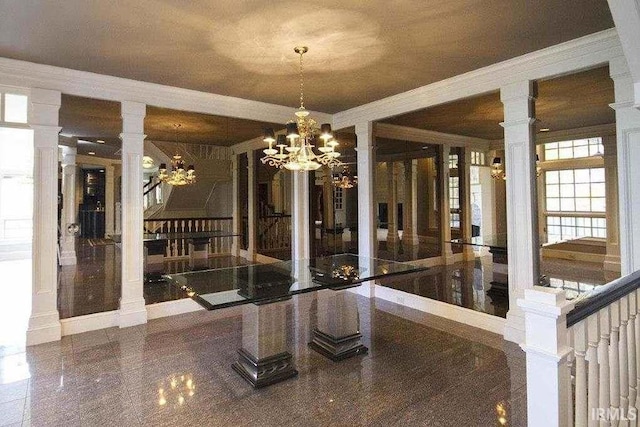 2314 Turnberry Ln, Fort Wayne, IN 46814 - unfurnished dining area featuring crown molding, a chandelier, and decorative columns