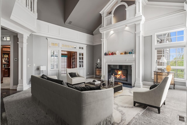 2314 Turnberry Ln, Fort Wayne, IN 46814 - living room with high vaulted ceiling, a tile fireplace, baseboards, and ornate columns