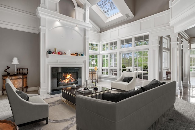 2314 Turnberry Ln, Fort Wayne, IN 46814 - living area featuring high vaulted ceiling, a warm lit fireplace, a skylight, and ornate columns
