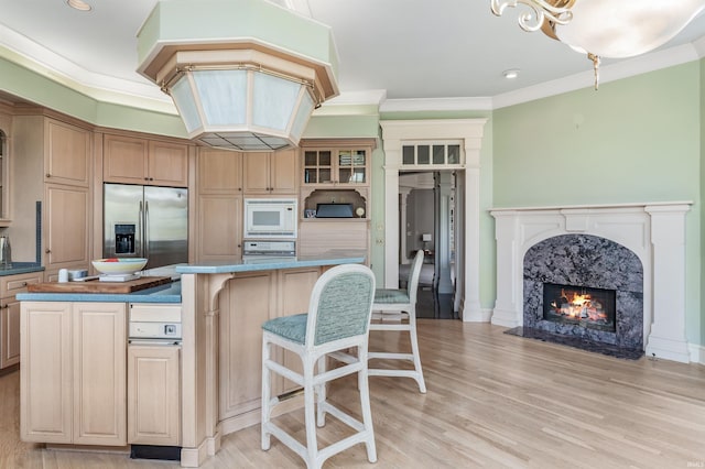 2314 Turnberry Ln, Fort Wayne, IN 46814 - kitchen with white microwave, stainless steel fridge, a kitchen bar, a kitchen island, and oven