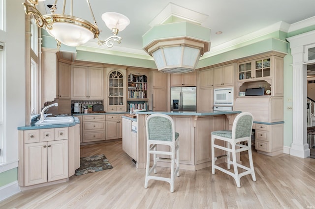 2314 Turnberry Ln, Fort Wayne, IN 46814 - kitchen with stainless steel fridge, white microwave, a sink, a breakfast bar, and a center island