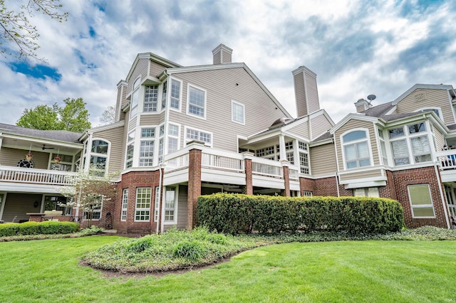 2314 Turnberry Ln, Fort Wayne, IN 46814 - back of property featuring brick siding, a lawn, and a chimney