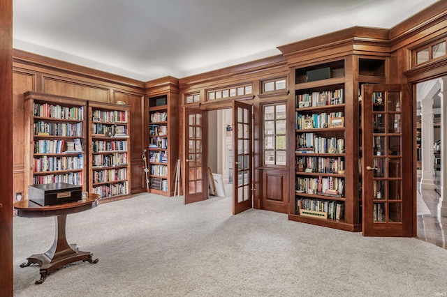 2314 Turnberry Ln, Fort Wayne, IN 46814 - sitting room featuring french doors, carpet, bookshelves, and wooden walls