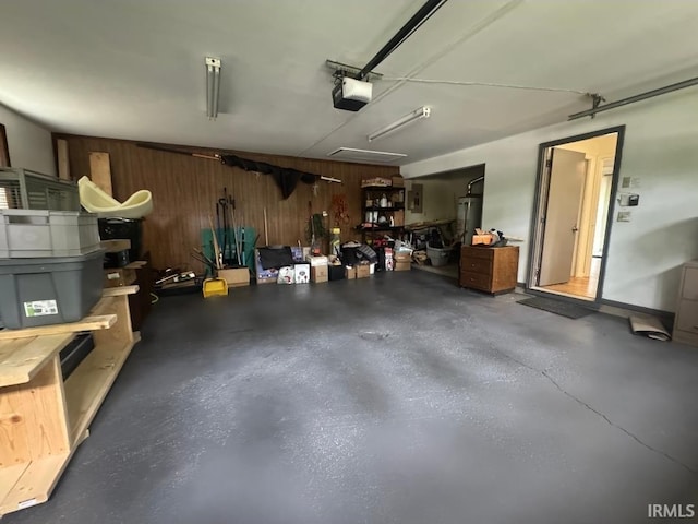 10704 Longwood Dr, Fort Wayne, IN 46845 - garage featuring wooden walls, a garage door opener, and water heater
