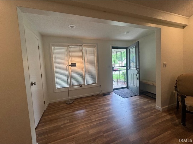 10704 Longwood Dr, Fort Wayne, IN 46845 - foyer entrance with dark wood-style floors and baseboards