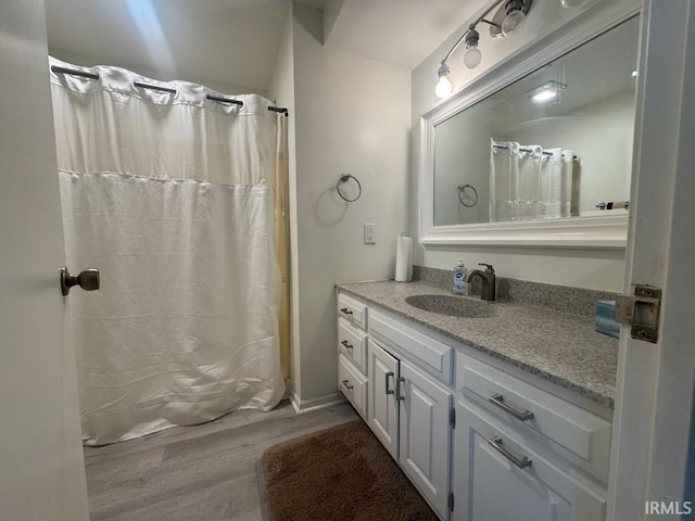10704 Longwood Dr, Fort Wayne, IN 46845 - bathroom with wood finished floors, vanity, and curtained shower