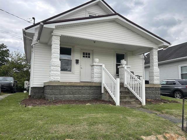 1338 Dewey St, Jasper, IN 47546 - shotgun-style home featuring a porch and a front yard