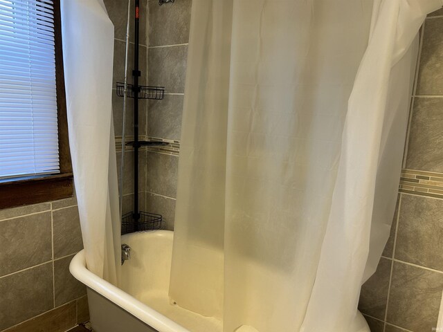 1338 Dewey St, Jasper, IN 47546 - bathroom with tile walls and shower / tub combo