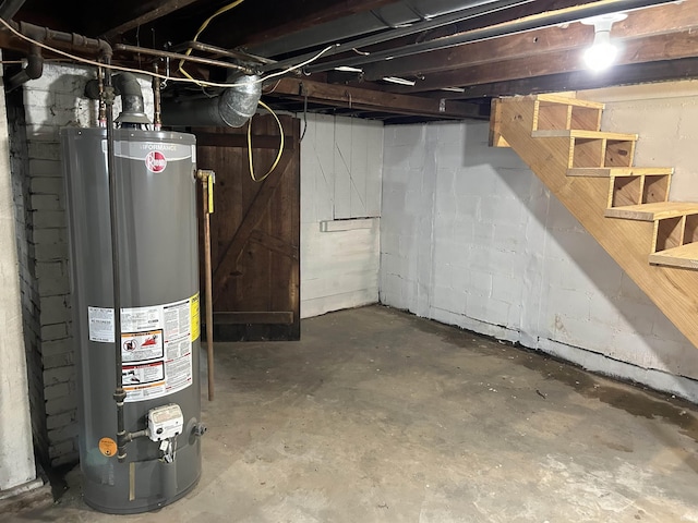 1338 Dewey St, Jasper, IN 47546 - unfinished below grade area with water heater, stairway, and concrete block wall
