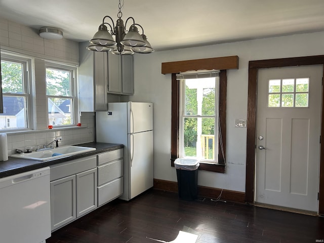 1338 Dewey St, Jasper, IN 47546 - kitchen with white appliances, a sink, dark countertops, and a chandelier
