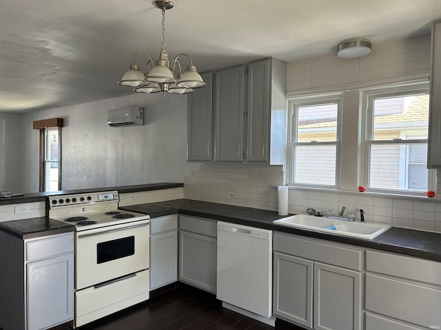 1338 Dewey St, Jasper, IN 47546 - kitchen with white appliances, a sink, a peninsula, and dark countertops