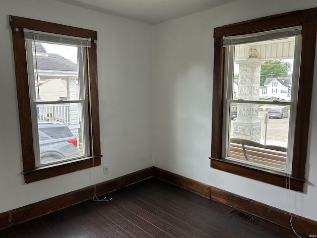 1338 Dewey St, Jasper, IN 47546 - spare room with dark wood-type flooring, plenty of natural light, and baseboards