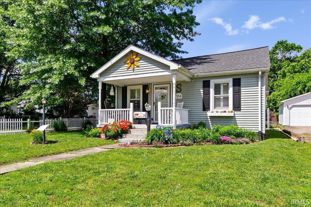 514 N Lemcke Ave, Evansville, IN 47712 - bungalow with covered porch, roof with shingles, and an outdoor structure