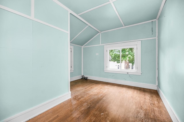 318 E Monroe St, Goshen, IN 46526 - bonus room featuring wood finished floors, baseboards, and lofted ceiling