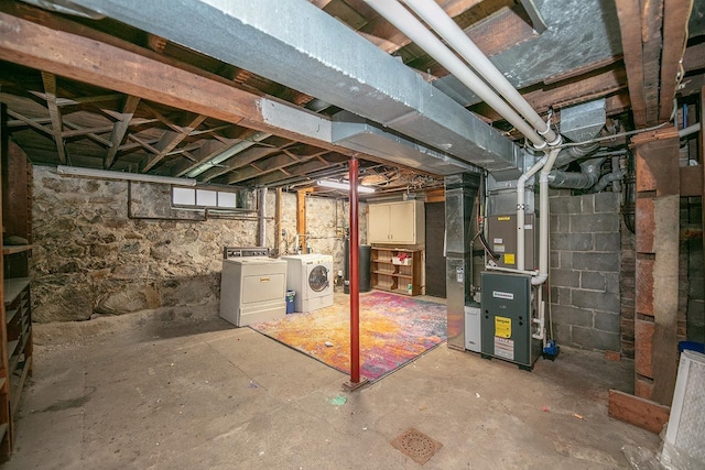 318 E Monroe St, Goshen, IN 46526 - below grade area with washing machine and dryer, heating unit, and water heater