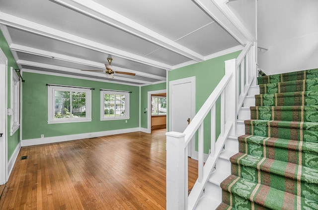 318 E Monroe St, Goshen, IN 46526 - stairs with beamed ceiling, ceiling fan, baseboards, and hardwood / wood-style flooring