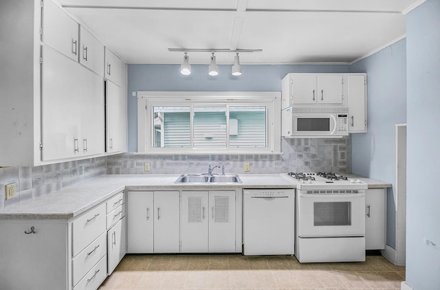 318 E Monroe St, Goshen, IN 46526 - kitchen featuring white appliances, a sink, decorative backsplash, white cabinets, and light countertops