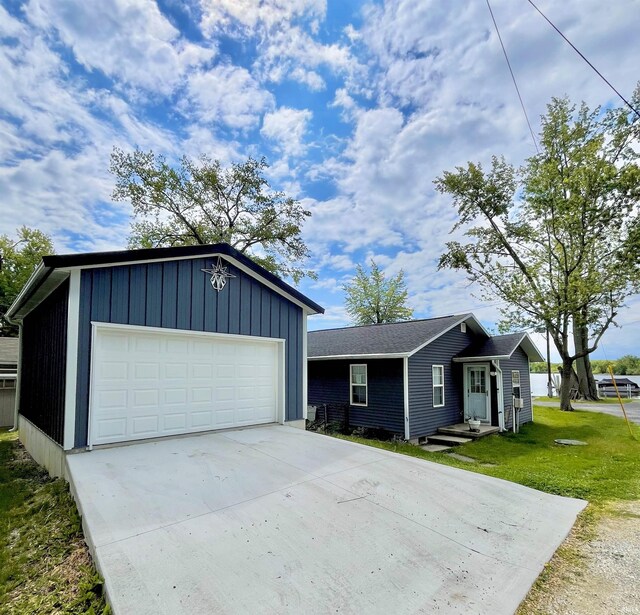 34 Ems B59 Ln, Warsaw, IN 46582 - view of front of house featuring driveway, a garage, a front yard, and an outbuilding