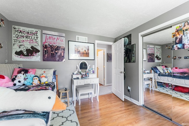8809 Newberry Dr, Fort Wayne, IN 46825 - bedroom with wood finished floors, a textured ceiling, and baseboards