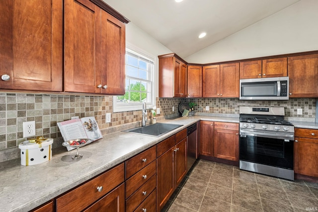 13849 Old Colony Dr, Granger, IN 46530 - kitchen with appliances with stainless steel finishes, a sink, vaulted ceiling, tasteful backsplash, and light countertops