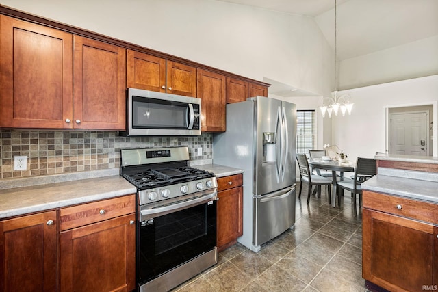13849 Old Colony Dr, Granger, IN 46530 - kitchen featuring appliances with stainless steel finishes, high vaulted ceiling, a chandelier, decorative backsplash, and brown cabinets
