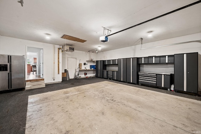 13849 Old Colony Dr, Granger, IN 46530 - garage with stainless steel refrigerator with ice dispenser and a garage door opener