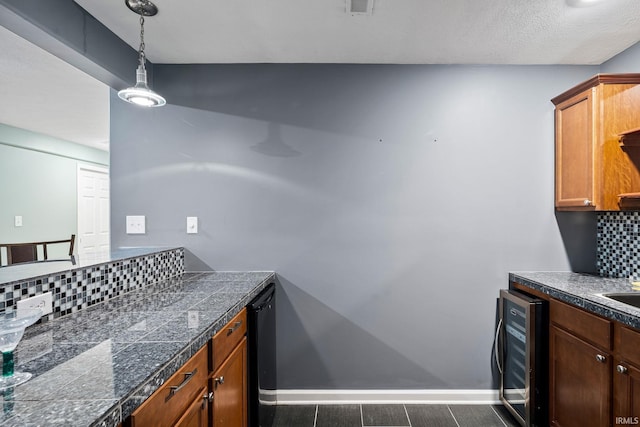 13849 Old Colony Dr, Granger, IN 46530 - kitchen featuring wine cooler, tile countertops, backsplash, baseboards, and decorative light fixtures