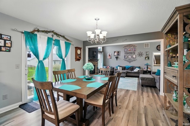 10221 Windsail Cv, New Haven, IN 46774 - dining room with a chandelier and light wood finished floors