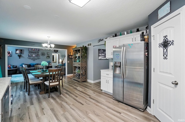 10221 Windsail Cv, New Haven, IN 46774 - dining area with a chandelier, light wood-style flooring, and baseboards