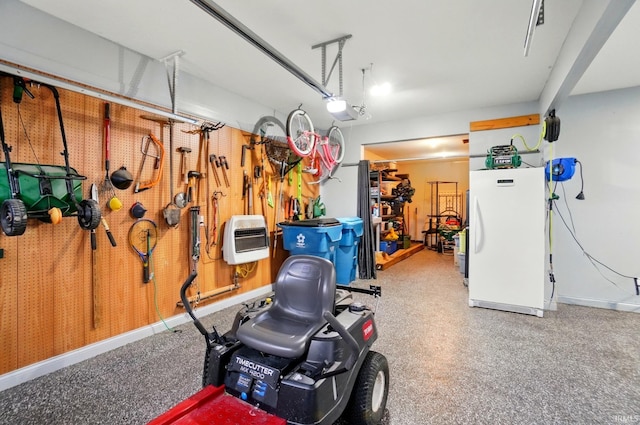 10221 Windsail Cv, New Haven, IN 46774 - garage featuring freestanding refrigerator, heating unit, a garage door opener, and baseboards