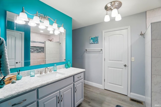 10221 Windsail Cv, New Haven, IN 46774 - full bath featuring vanity, a tile shower, wood finished floors, and baseboards