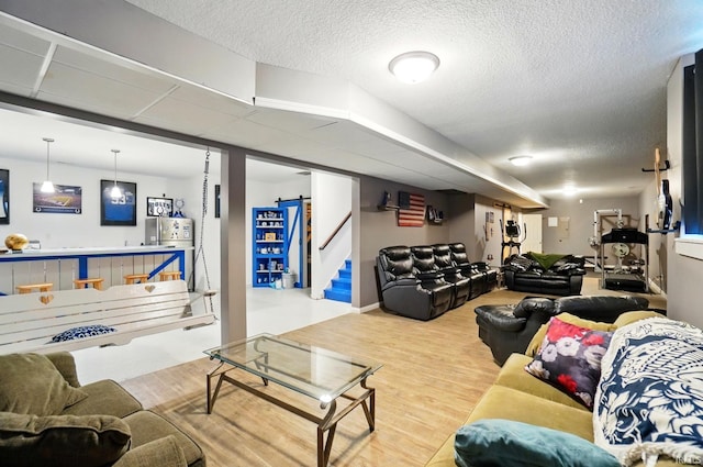 10221 Windsail Cv, New Haven, IN 46774 - living room featuring wood finished floors, a textured ceiling, and stairs