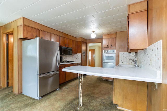 54188 Terrace Ln, South Bend, IN 46635 - kitchen with appliances with stainless steel finishes, a sink, a peninsula, tasteful backsplash, and light countertops