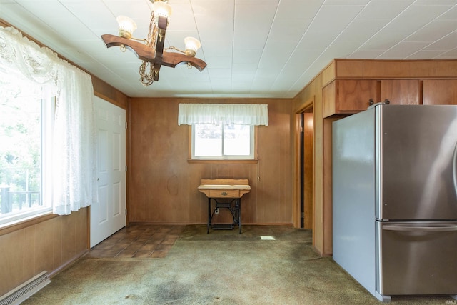 54188 Terrace Ln, South Bend, IN 46635 - kitchen with freestanding refrigerator, a chandelier, carpet floors, and wooden walls