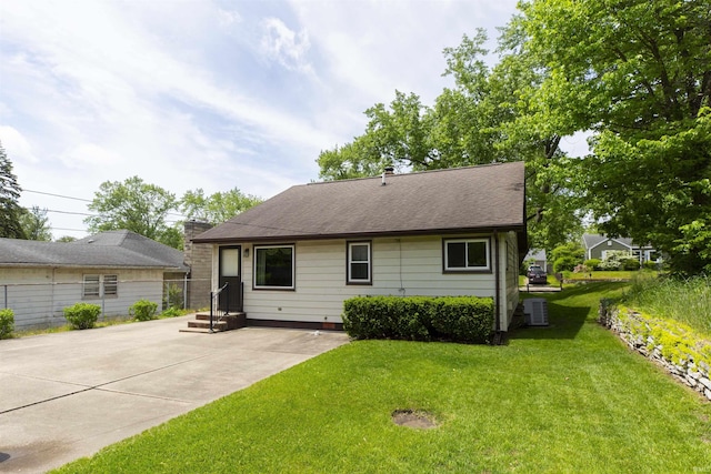 54188 Terrace Ln, South Bend, IN 46635 - rear view of house with a yard, roof with shingles, and central AC