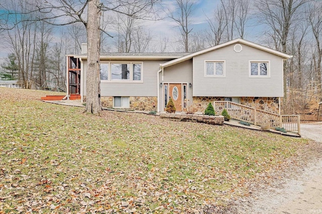 5959 W Delap Rd, Ellettsville, IN 47429 - split foyer home with a front lawn, a sunroom, and stone siding