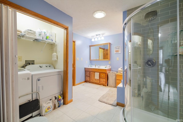 5959 W Delap Rd, Ellettsville, IN 47429 - full bathroom featuring tile patterned flooring, a shower stall, vanity, washer and dryer, and baseboards