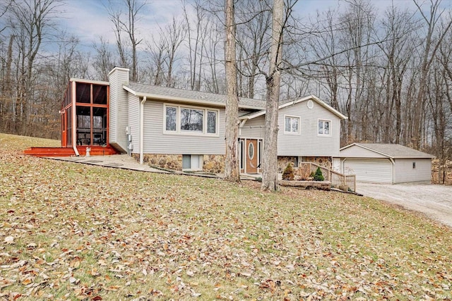 5959 W Delap Rd, Ellettsville, IN 47429 - raised ranch with a chimney, an outdoor structure, a detached garage, a sunroom, and a front yard