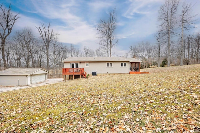 5959 W Delap Rd, Ellettsville, IN 47429 - rear view of house featuring a sunroom, a detached garage, a deck, an outdoor structure, and cooling unit