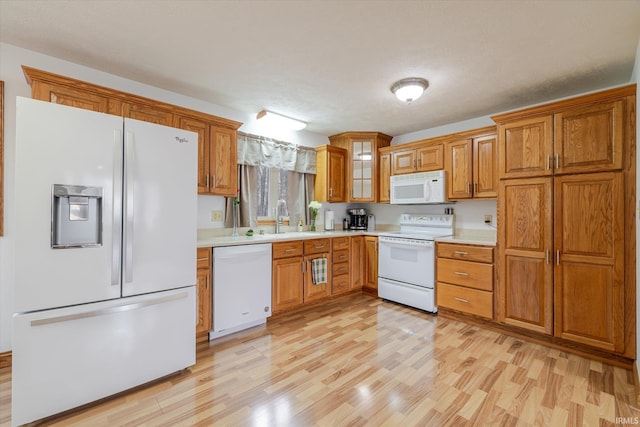 5959 W Delap Rd, Ellettsville, IN 47429 - kitchen featuring white appliances, brown cabinetry, light wood-style flooring, and light countertops