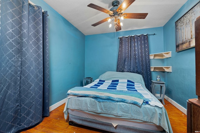 3902 Grayston Ave, Fort Wayne, IN 46806 - bedroom with wood finished floors, baseboards, ceiling fan, and a textured ceiling
