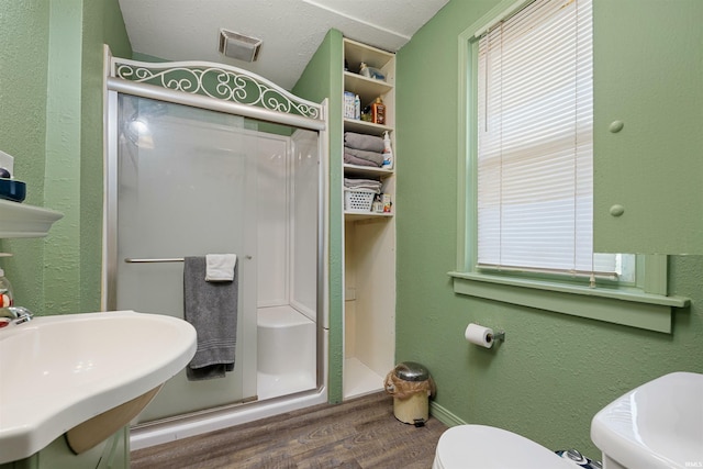 3902 Grayston Ave, Fort Wayne, IN 46806 - full bath with wood finished floors, a stall shower, a sink, toilet, and a textured wall