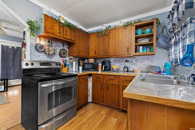 3902 Grayston Ave, Fort Wayne, IN 46806 - kitchen featuring stainless steel range with electric stovetop, a sink, black microwave, and brown cabinetry