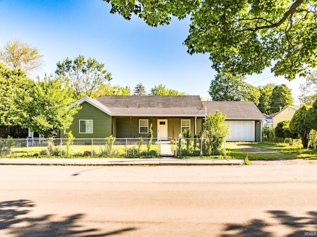 1804 W 14th St, Muncie, IN 47302 - ranch-style home with an attached garage, a fenced front yard, and driveway