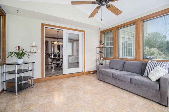 51178 Ashley Dr, Granger, IN 46530 - living area with lofted ceiling, a ceiling fan, baseboards, and a chandelier