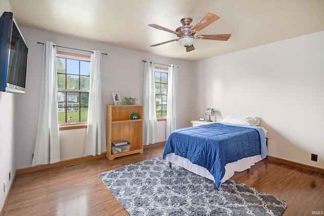 51178 Ashley Dr, Granger, IN 46530 - bedroom featuring multiple windows, wood finished floors, and ceiling fan