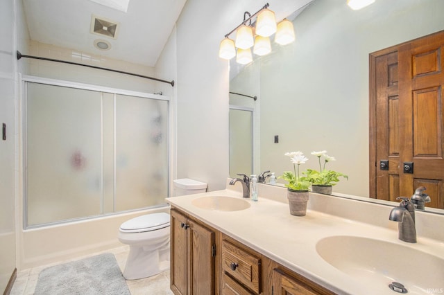 51178 Ashley Dr, Granger, IN 46530 - full bathroom featuring toilet, double vanity, bath / shower combo with glass door, and tile patterned floors