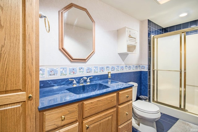 51178 Ashley Dr, Granger, IN 46530 - bathroom with vanity, toilet, a stall shower, and tile patterned flooring